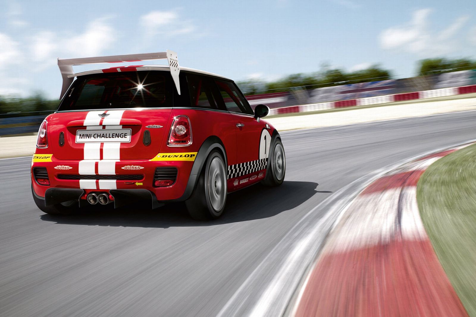 A red MINI race car cornering on track
